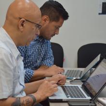 Periodistas digitales independientes participando en el taller frente a su computadora portatil